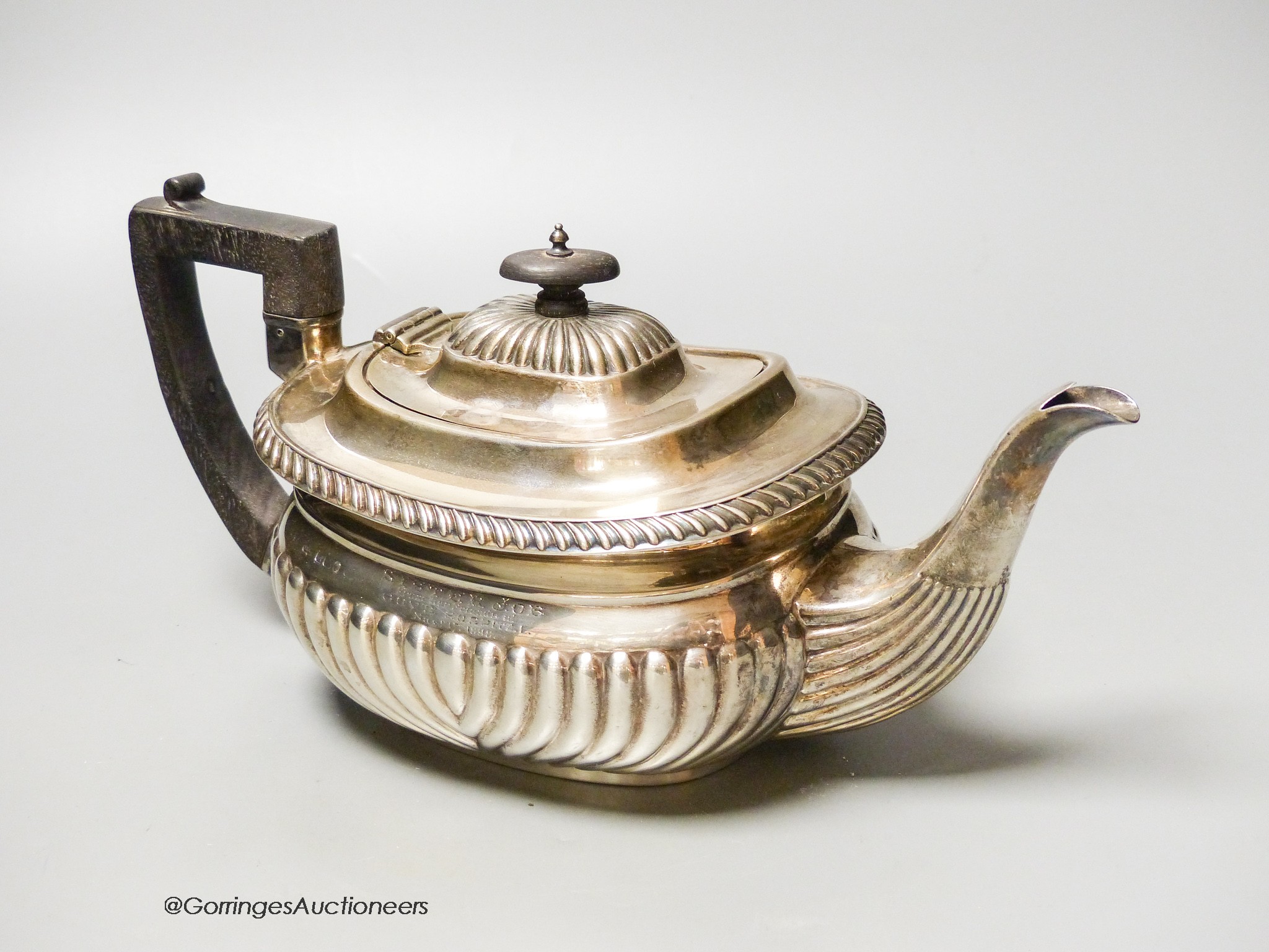 A Mappin & Webb fluted silver teapot, Sheffield, (marks rubbed) presented to ‘Sister Job, From Her Friends at Guy’s Hospital, 1898, gross 23 oz.